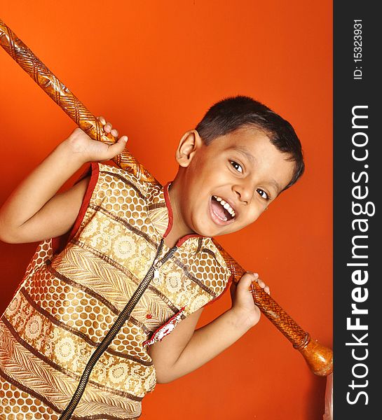 A little Indian boy with a long wooden club. A little Indian boy with a long wooden club.