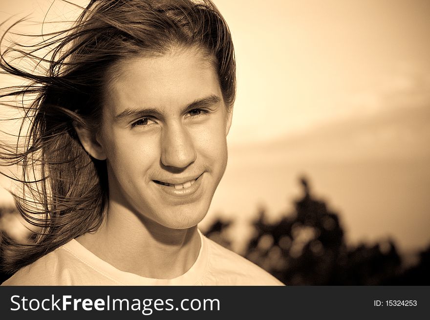 Monochrome portrait of a teenager with flying long hair, against the sky. Monochrome portrait of a teenager with flying long hair, against the sky