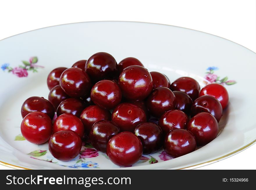 Juicy ripe cherries lay on a plate. Image is processed from NEF files and are retouched to achieve the best possible image quality. Closeup. Juicy ripe cherries lay on a plate. Image is processed from NEF files and are retouched to achieve the best possible image quality. Closeup