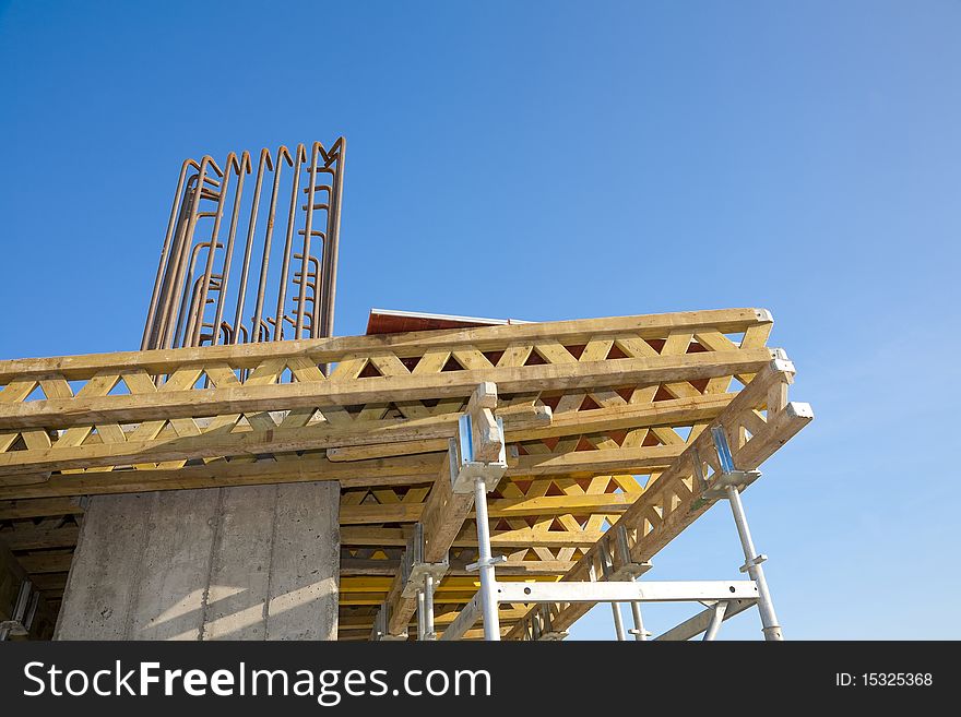 Scafolding structure on a construction site, against clear blue skies