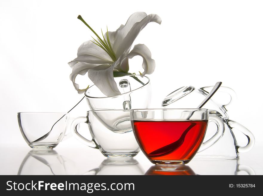 6 glass tea cups and flower with reflection on white at 10Mps. 6 glass tea cups and flower with reflection on white at 10Mps