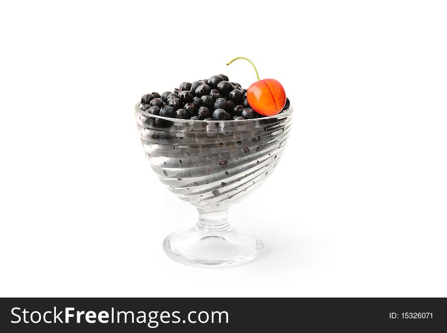 Blueberries and cherry in a glass bowl isolated on white. Blueberries and cherry in a glass bowl isolated on white