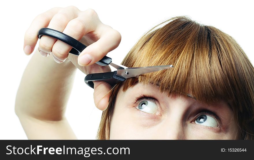 Young woman with scissors over white