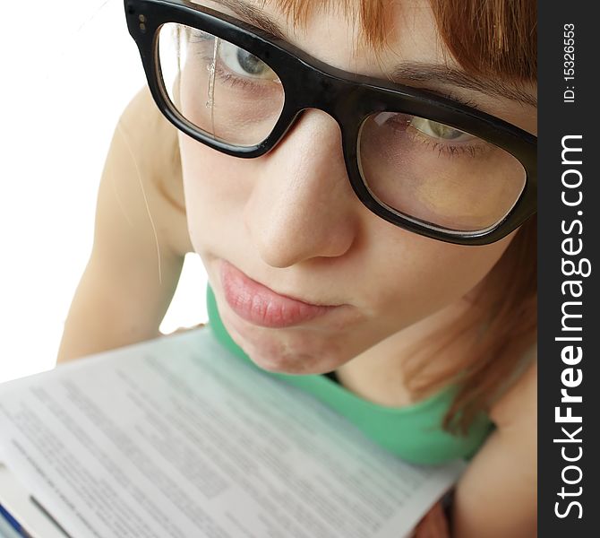 Young sad woman in broken retro glasses and heap of papers