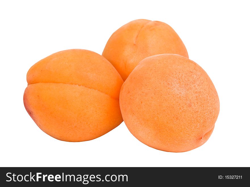 Three apricots isolated on a white background