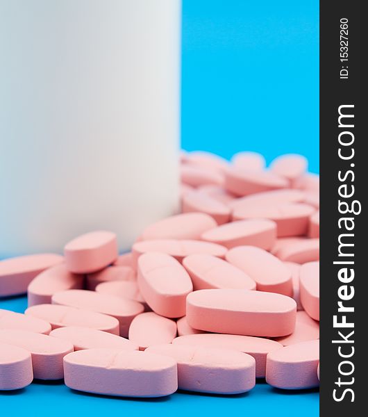 Closeup photo of pills on blue back ground.