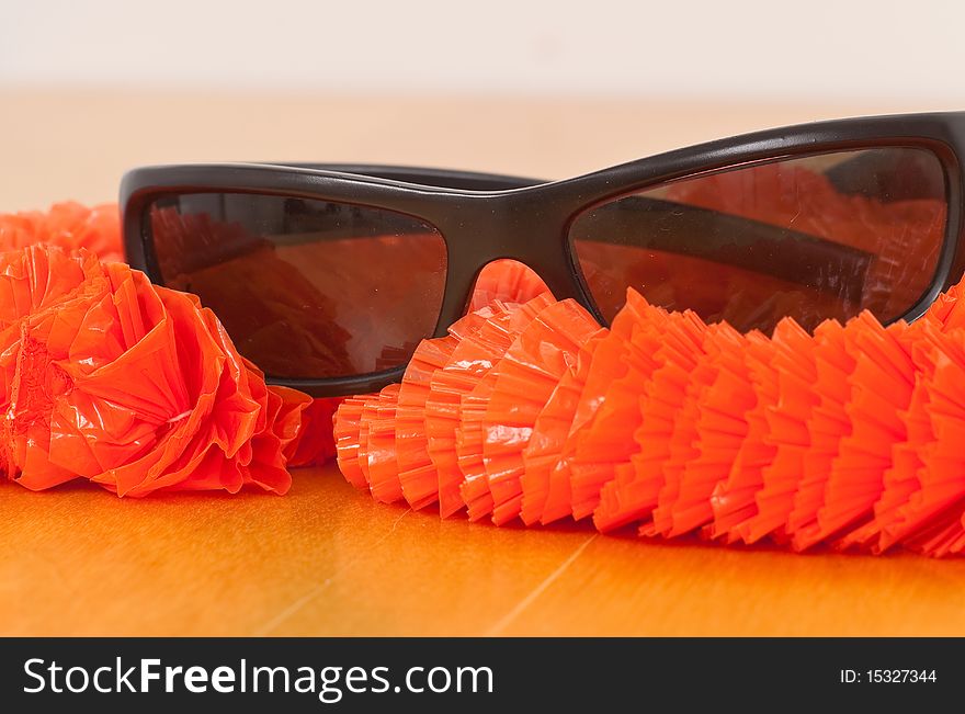 Sunglasses With Orange Plastic Lei. Sunglasses With Orange Plastic Lei