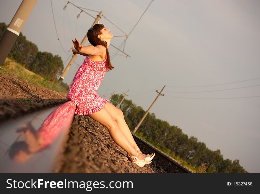 A beautiful girl sitting on rails. A beautiful girl sitting on rails