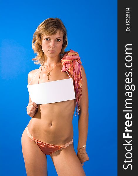 Beautiful topless girl holing white blank sign to write your own message. Girl isolated on the blue background