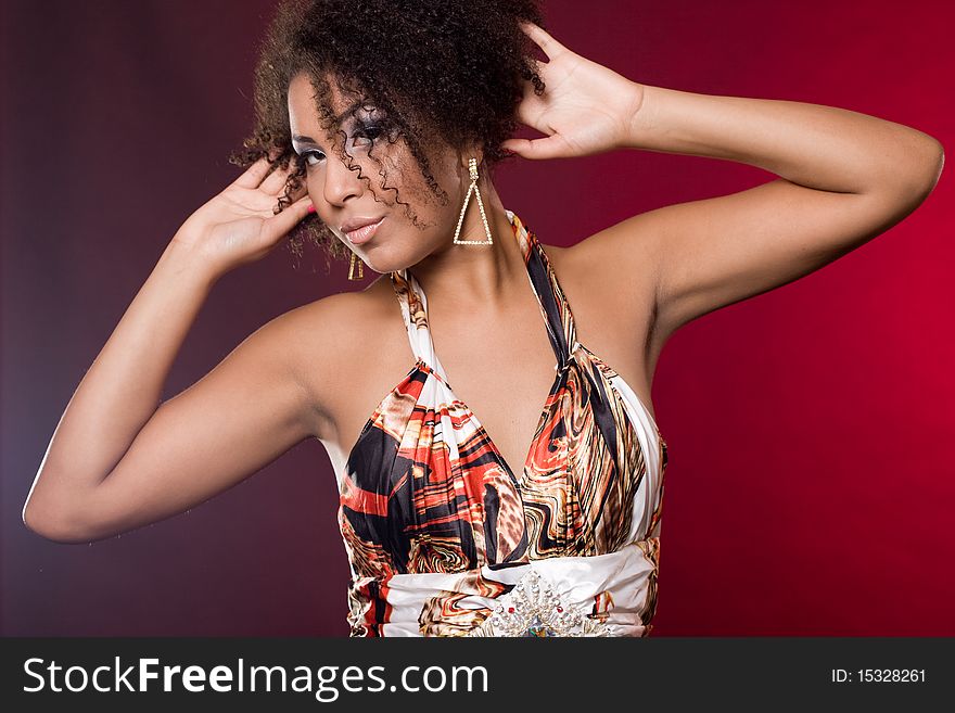 Fashionable mulatto woman on red