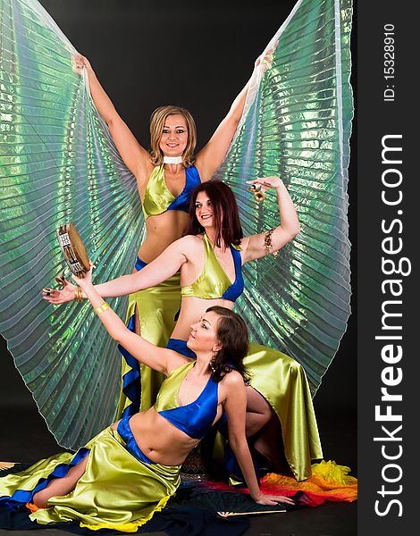 Group of three women perfoming exotic belly dance. Group of three women perfoming exotic belly dance