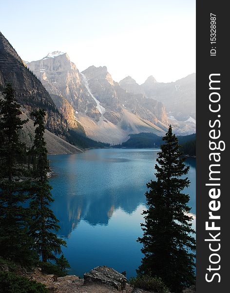 This is Beautiful Moraine Lake in The Canadian Rockies.  This glacier lake gets its crystal blue water look from silt on the bottom.