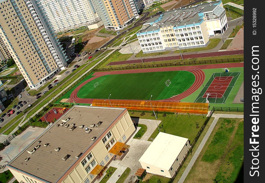 Empty school soccer stadium, football field, basketball court, a top view, shot from a height, Moscow, Russia. Empty school soccer stadium, football field, basketball court, a top view, shot from a height, Moscow, Russia