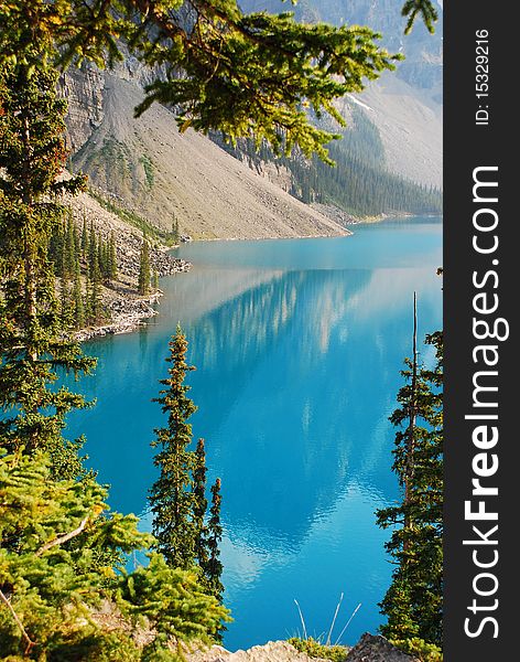 This is Beautiful Moraine Lake in The Canadian Rockies.  This glacier lake gets its crystal blue water look from silt on the bottom.