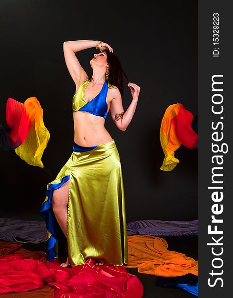 Beautiful belly dancer woman in front of black background