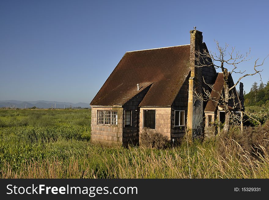 Old abandoned homestead in a marshy area along the Columbia River. Old abandoned homestead in a marshy area along the Columbia River.