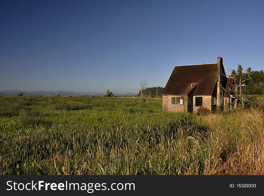 Old abandoned homestead in a marshy area along the Columbia River. Old abandoned homestead in a marshy area along the Columbia River.