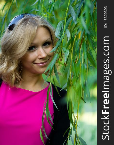 An attractive girl's portrait, her face seen through some green leaves. An attractive girl's portrait, her face seen through some green leaves