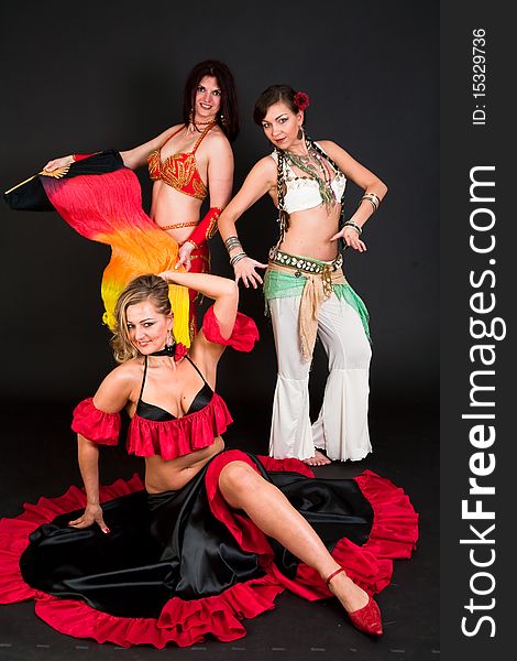 Group of three women perfoming exotic belly dance. Group of three women perfoming exotic belly dance