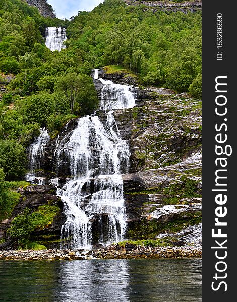 The Seven Sisters spectacular waterfall at Geirangerfjord seens by boat trip, Sunnmore region, Norway,  most beautiful fjords in the world, included on the UNESCO World Heritage.