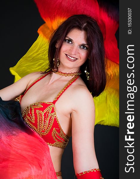 Beautiful belly dancer woman in front of black background