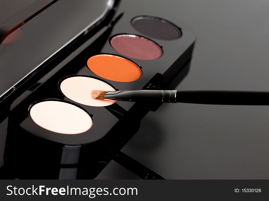 Make-up eyeshadows and cosmetic brush