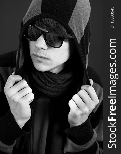Black & white portrait of cool teen male holding his hoodie. Black & white portrait of cool teen male holding his hoodie