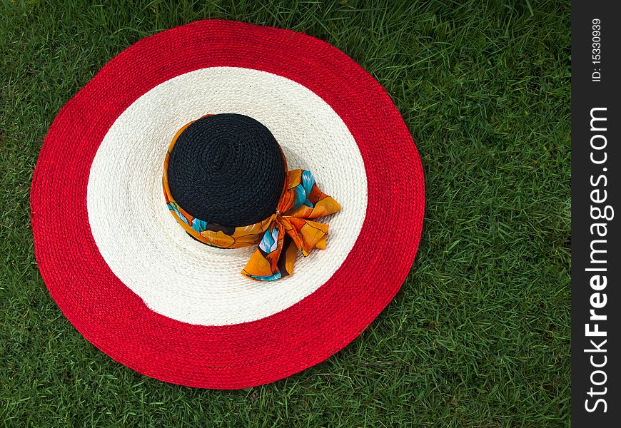 Red white and black big round straw hat. Red white and black big round straw hat