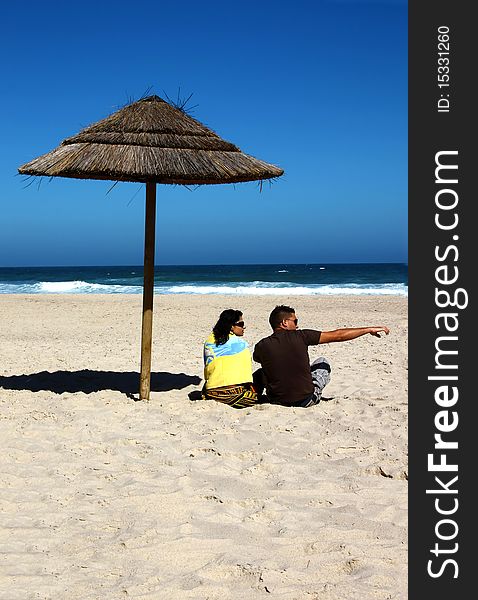 Attractive lovely couple relaxing on the beach. Attractive lovely couple relaxing on the beach