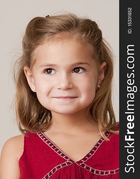 Portrait of pretty little 5 year old girl with blond hair and red dress. Portrait of pretty little 5 year old girl with blond hair and red dress.