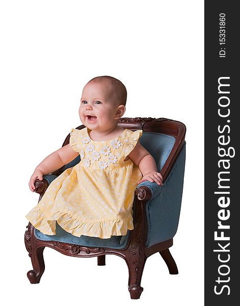 Cute baby wearing yellow dress sitting in chair on white background. Cute baby wearing yellow dress sitting in chair on white background