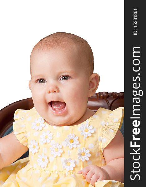 Cute baby wearing yellow dress sitting in chair on white background. Cute baby wearing yellow dress sitting in chair on white background