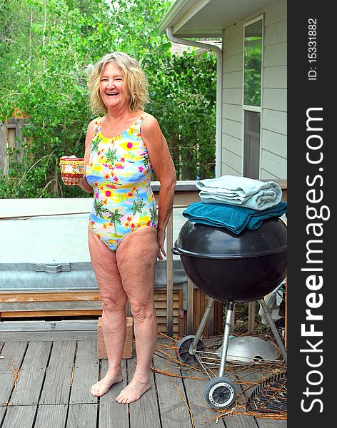 Mature female beauty enjoying her morning coffee and the hot tub.
