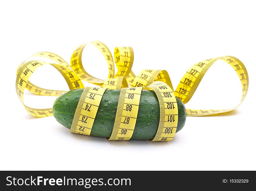 Cucumber with a measuring tape on white