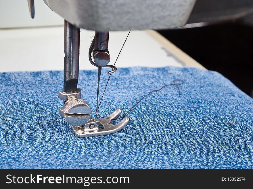 Sewing machine detail with jeans material