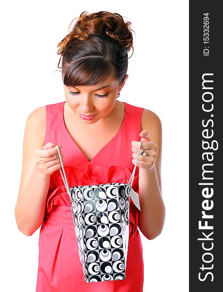 Young woman holding shopping bag over white background