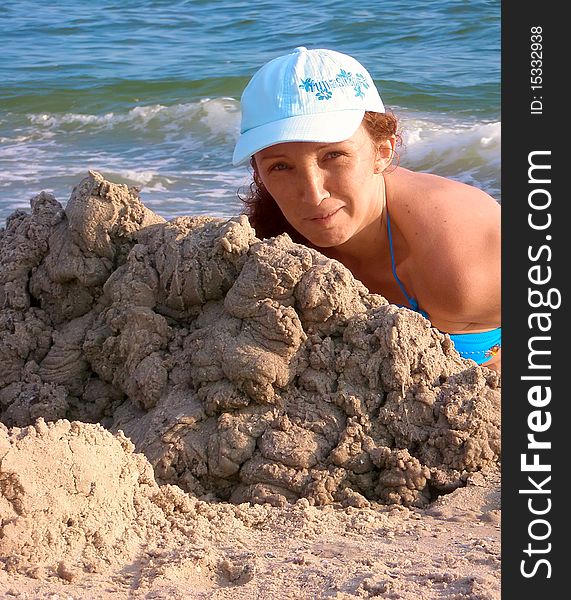 Woman of the sea. In the foreground, pile of wet sand