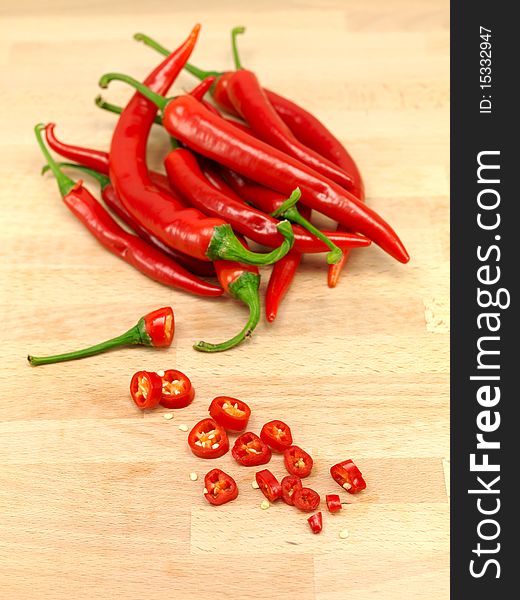 Red chilli peppers on a wooden bench