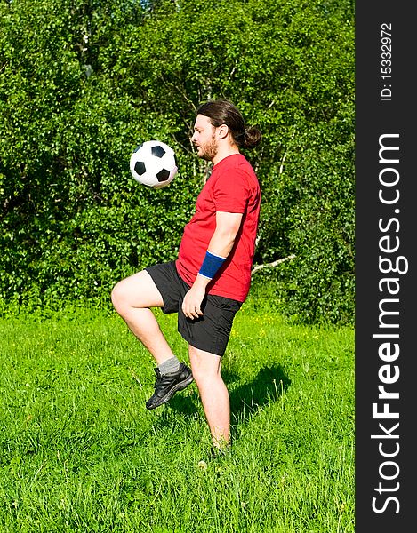 Portrait of man playing soccer on the grass. Portrait of man playing soccer on the grass