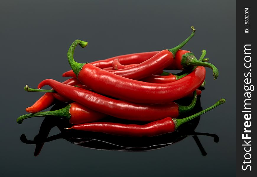 Red chilli peppers isolated against a black background