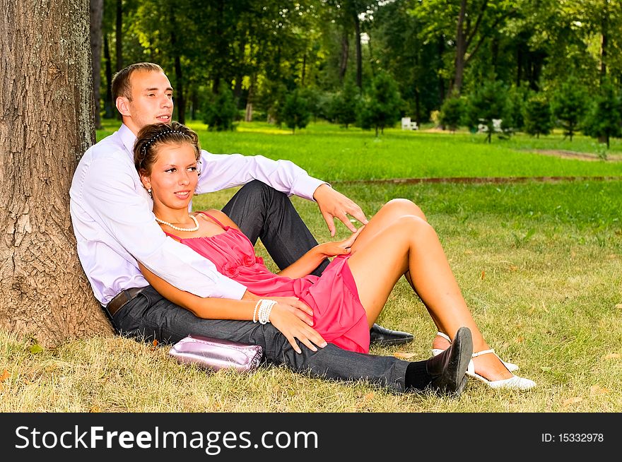 Portrit of young couple resting on the grass. Portrit of young couple resting on the grass