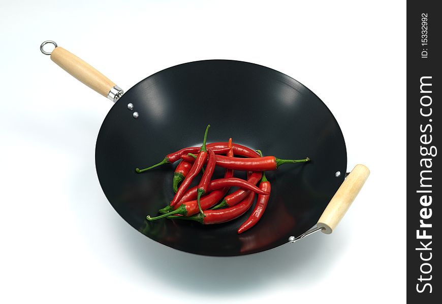 Red chilli peppers in a wok isolated against a white background