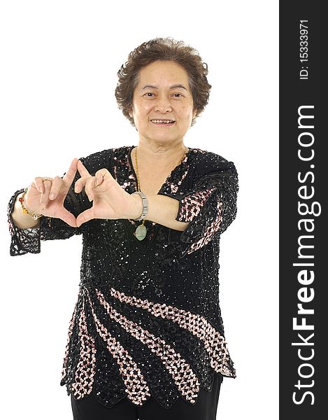 Portrait Of Senior woman making a heart gesture