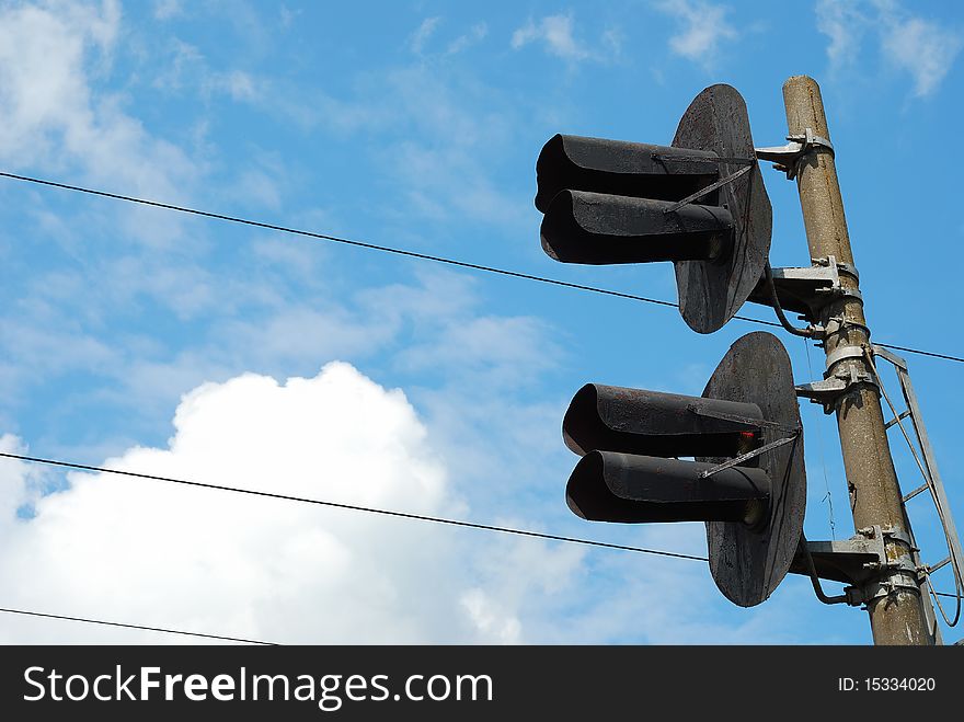 Railway traffic lights at blue sky background