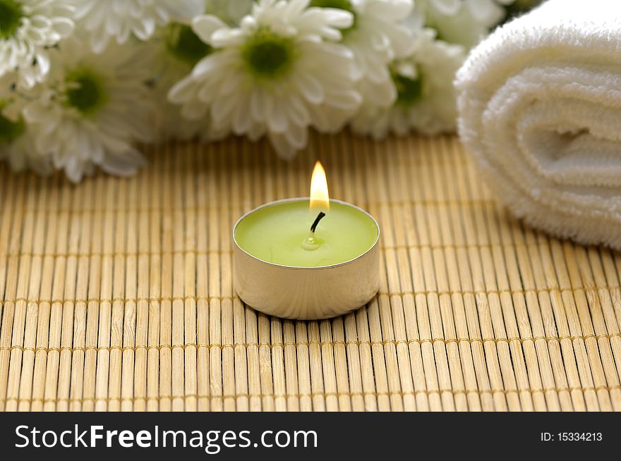 Spa composition. Towel, candle and flowers. Spa composition. Towel, candle and flowers.