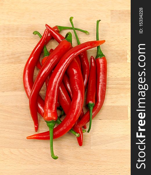 Red chilli peppers on a wooden bench