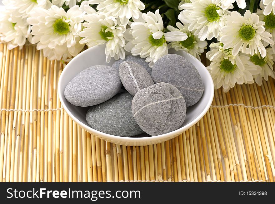 Bowl of pebbles with Chrysanthemums flowers. Bowl of pebbles with Chrysanthemums flowers