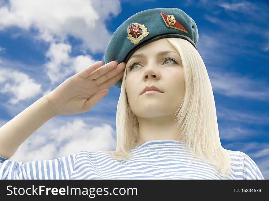 Woman in shape holds a hand near a headdress against the dark blue sky with clouds. Woman in shape holds a hand near a headdress against the dark blue sky with clouds