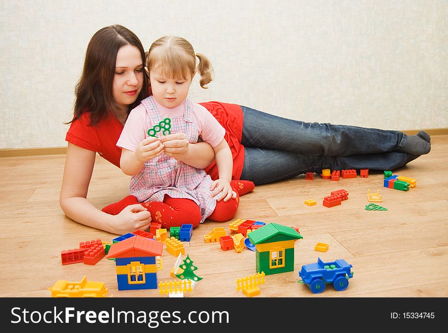 Mum with the daughter plaing at home