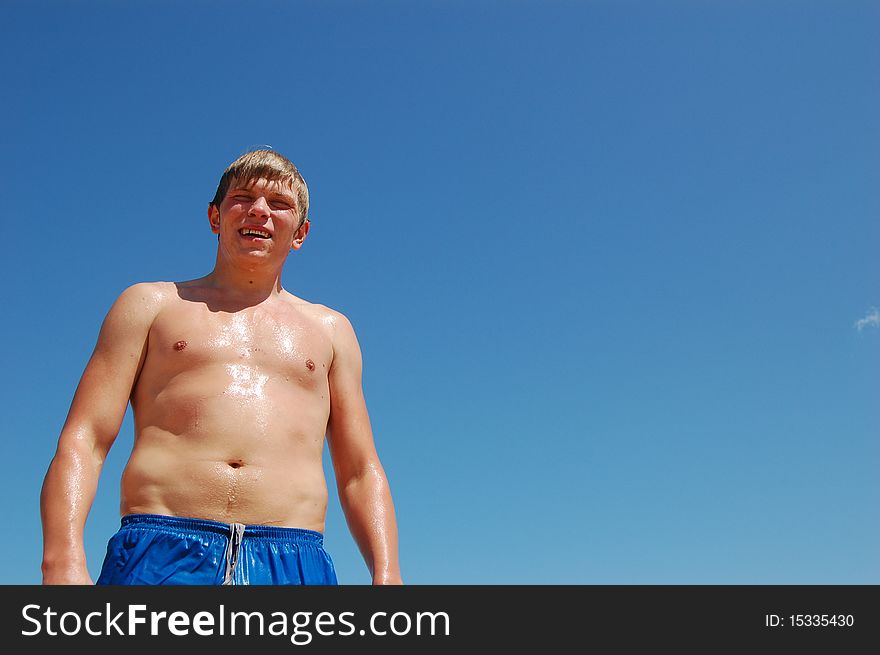 The young man after bathing against the blue sky. The young man after bathing against the blue sky